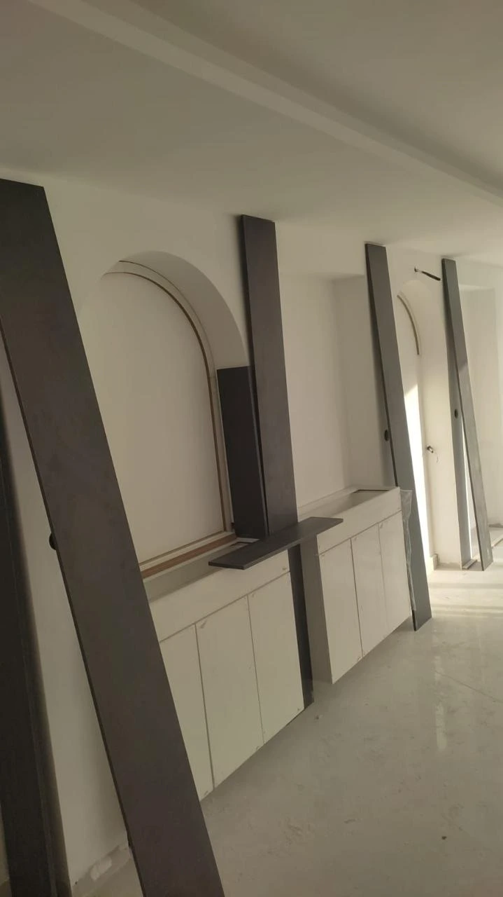 * Modern optical store interior design in Amman by Eagle Ports featuring luxury lighting and custom eyewear displays