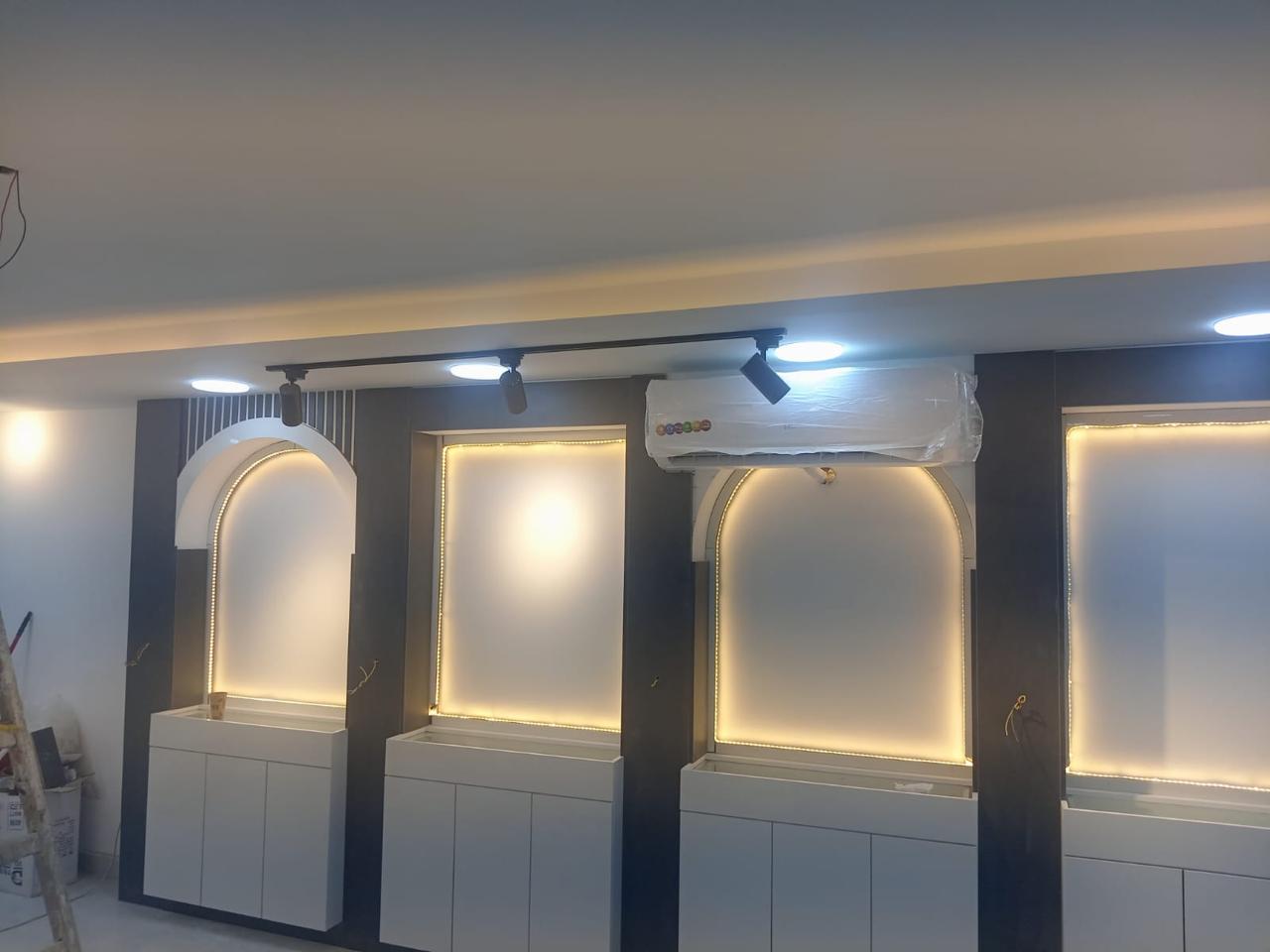 * Modern optical store interior design in Amman by Eagle Ports featuring luxury lighting and custom eyewear displays