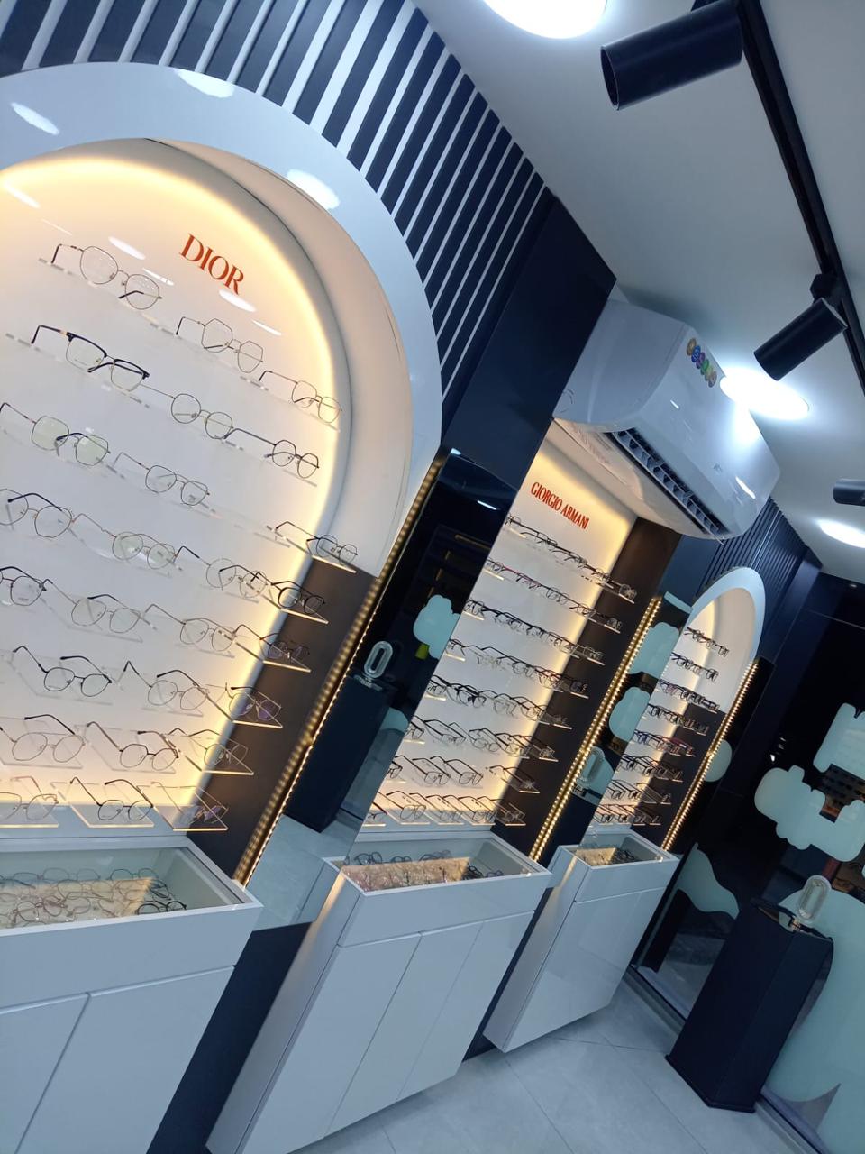 * High-end optical showroom interior design in Amman with wooden finishes and LED lighting